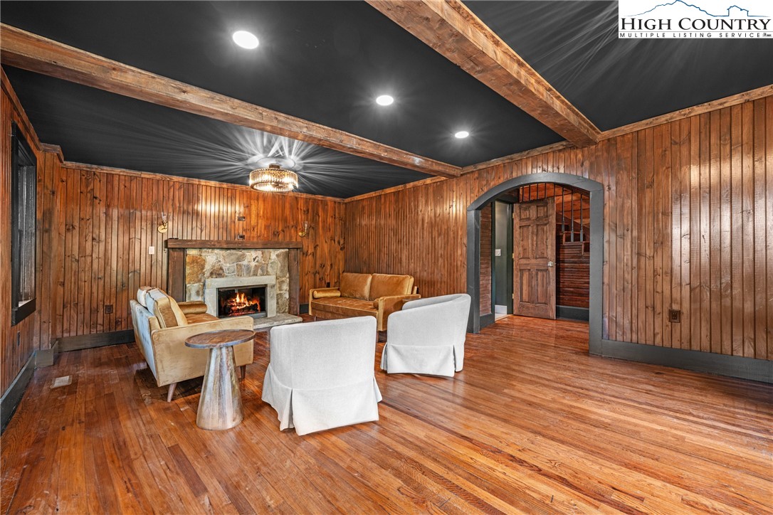 160 Old Tpke E Road Banner Elk, NC 28604 - Photo 22 of 50 a living room with furniture a fireplace and wooden floor