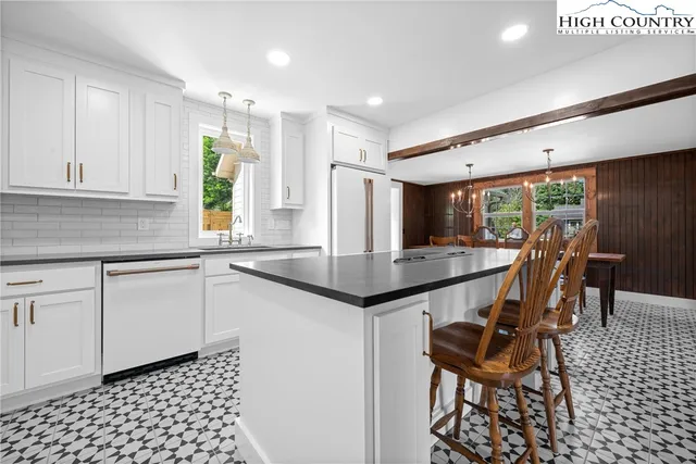 a kitchen with a sink a counter space and dining table