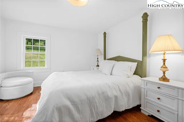 a bedroom with two beds and a window