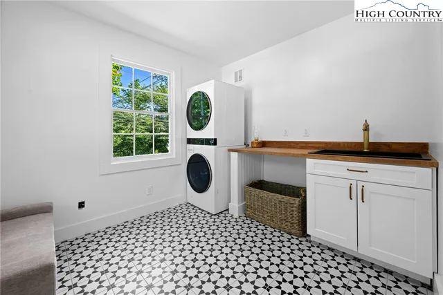 a bathroom with a sink a toilet and a window