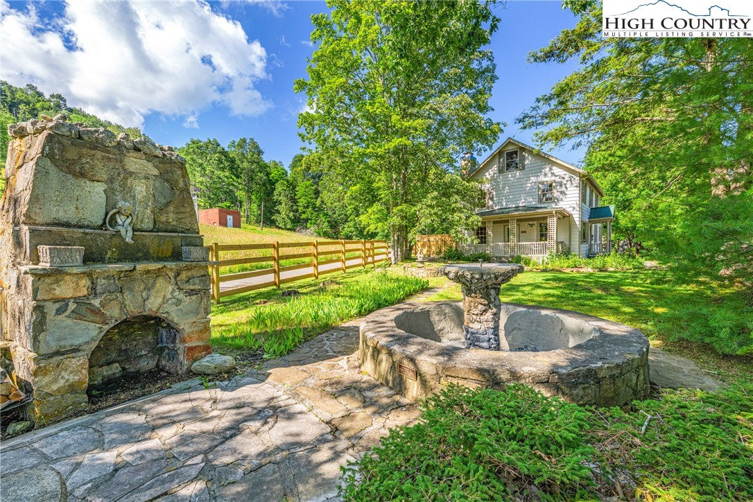 160 Old Tpke E Road Banner Elk, NC 28604 - Photo 45 of 50 a front view of a house with a garden and fountain
