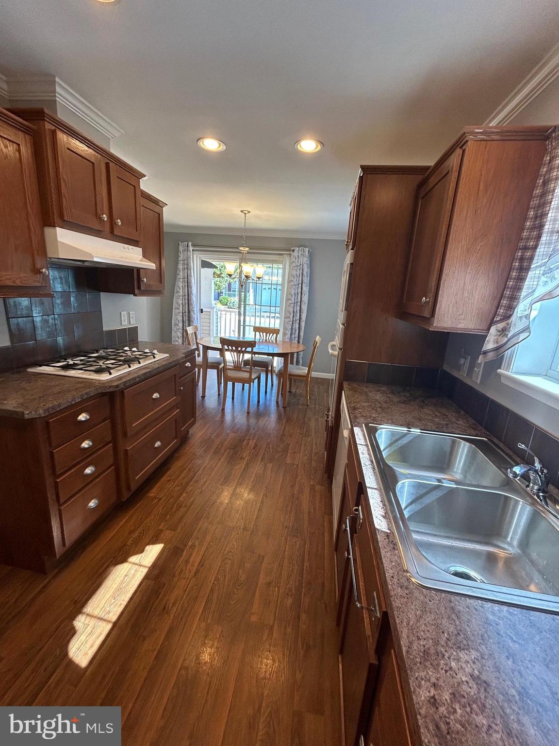 150 Random Road Douglassville, PA 19518 - Photo 9 of 32 a kitchen with granite countertop a stove a sink a refrigerator and wooden cabinets