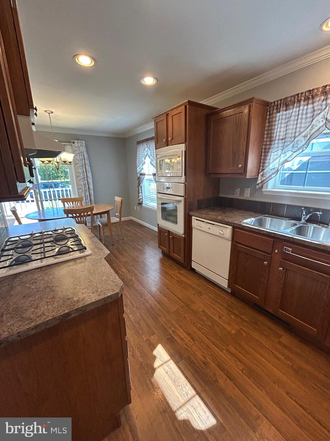 150 Random Road Douglassville, PA 19518 - Photo 10 of 32 a kitchen with stainless steel appliances granite countertop a sink a stove and a wooden floors