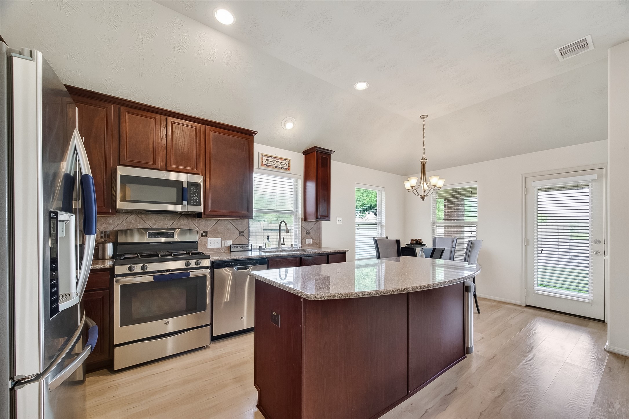 13415 Star Creek Lane Rosharon, TX 77583 - Photo 5 of 46 a kitchen with a sink stove and microwave