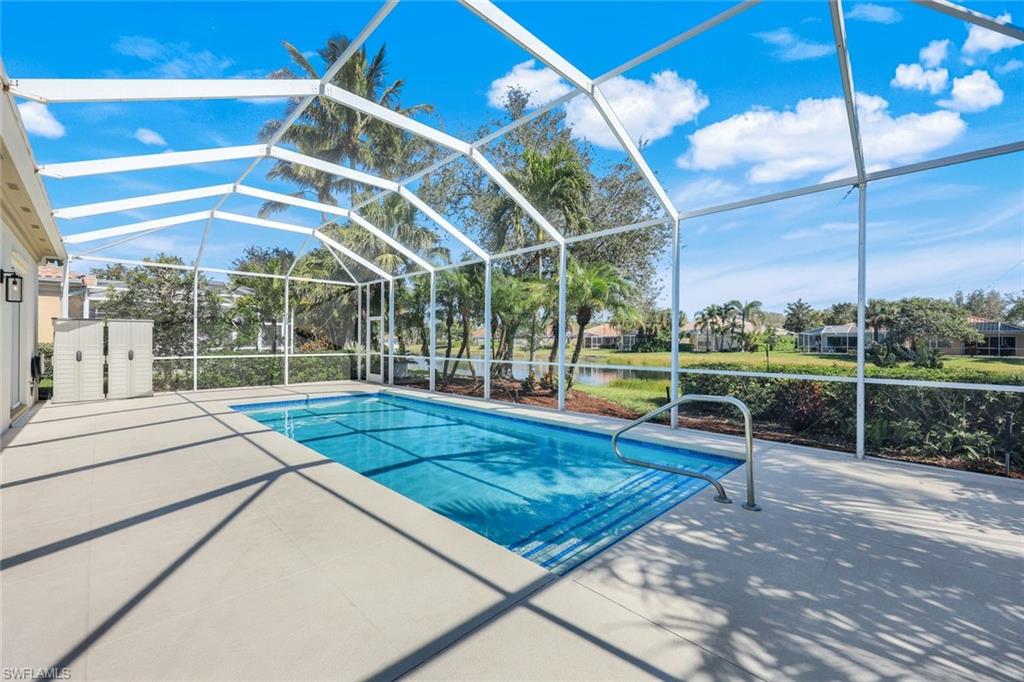 3108 Dominica Way Naples, FL 34119 - Photo 23 of 39 Screened enclosure featuring a heated saltwater swimming pool.