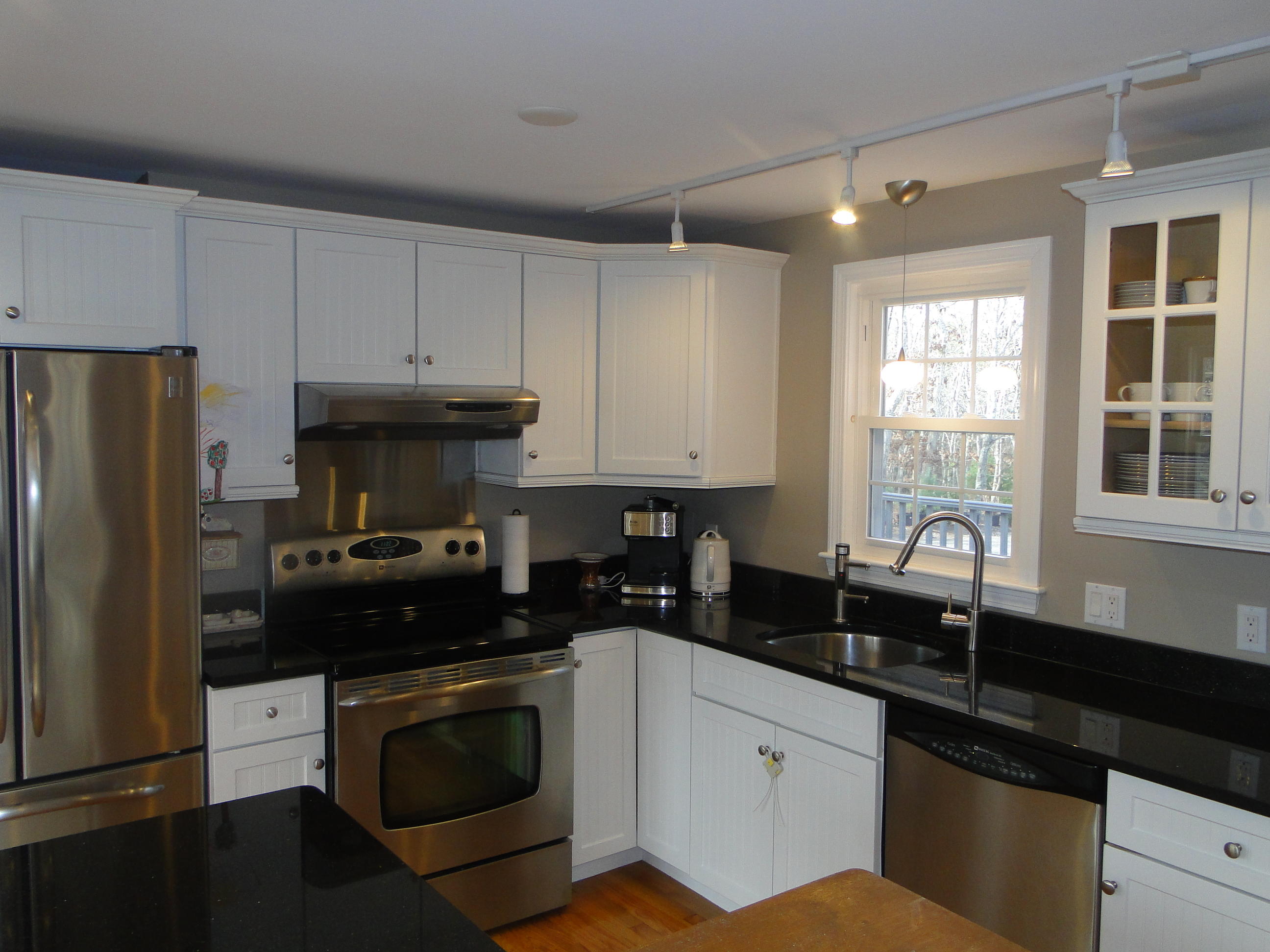 10 Bayview Road East Sandwich, MA 02537 - Photo 3 of 19 a kitchen with granite countertop white cabinets and stainless steel appliances