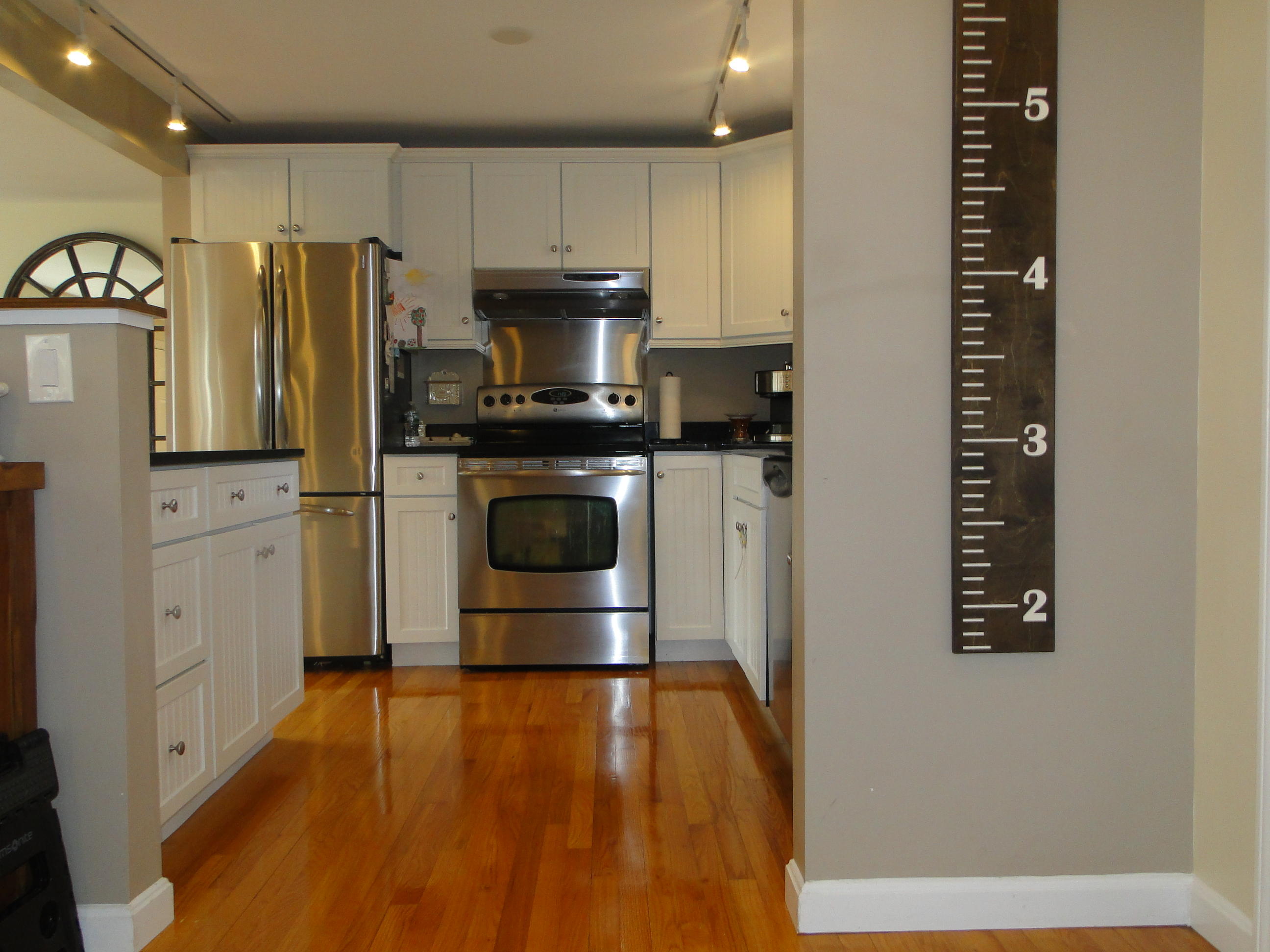 10 Bayview Road East Sandwich, MA 02537 - Photo 5 of 19 a kitchen with stainless steel appliances a refrigerator stove and white cabinets