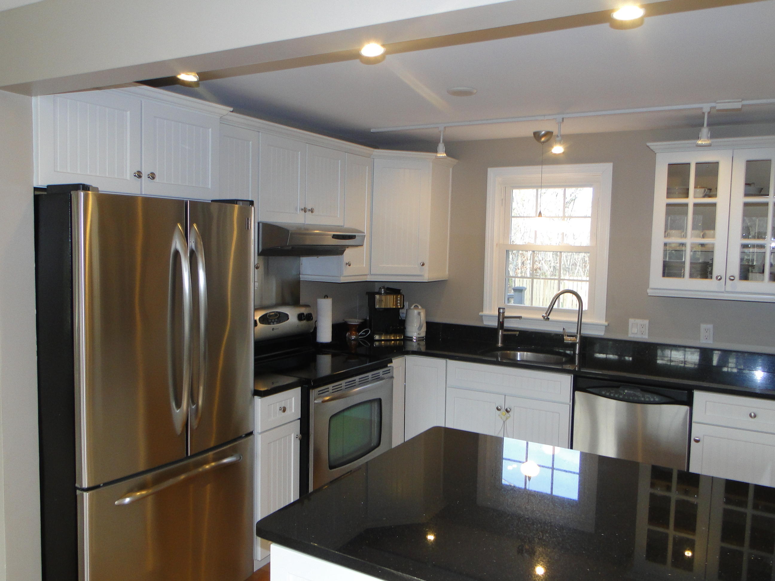 10 Bayview Road East Sandwich, MA 02537 - Photo 6 of 19 a kitchen with granite countertop a refrigerator a sink a stove and cabinets