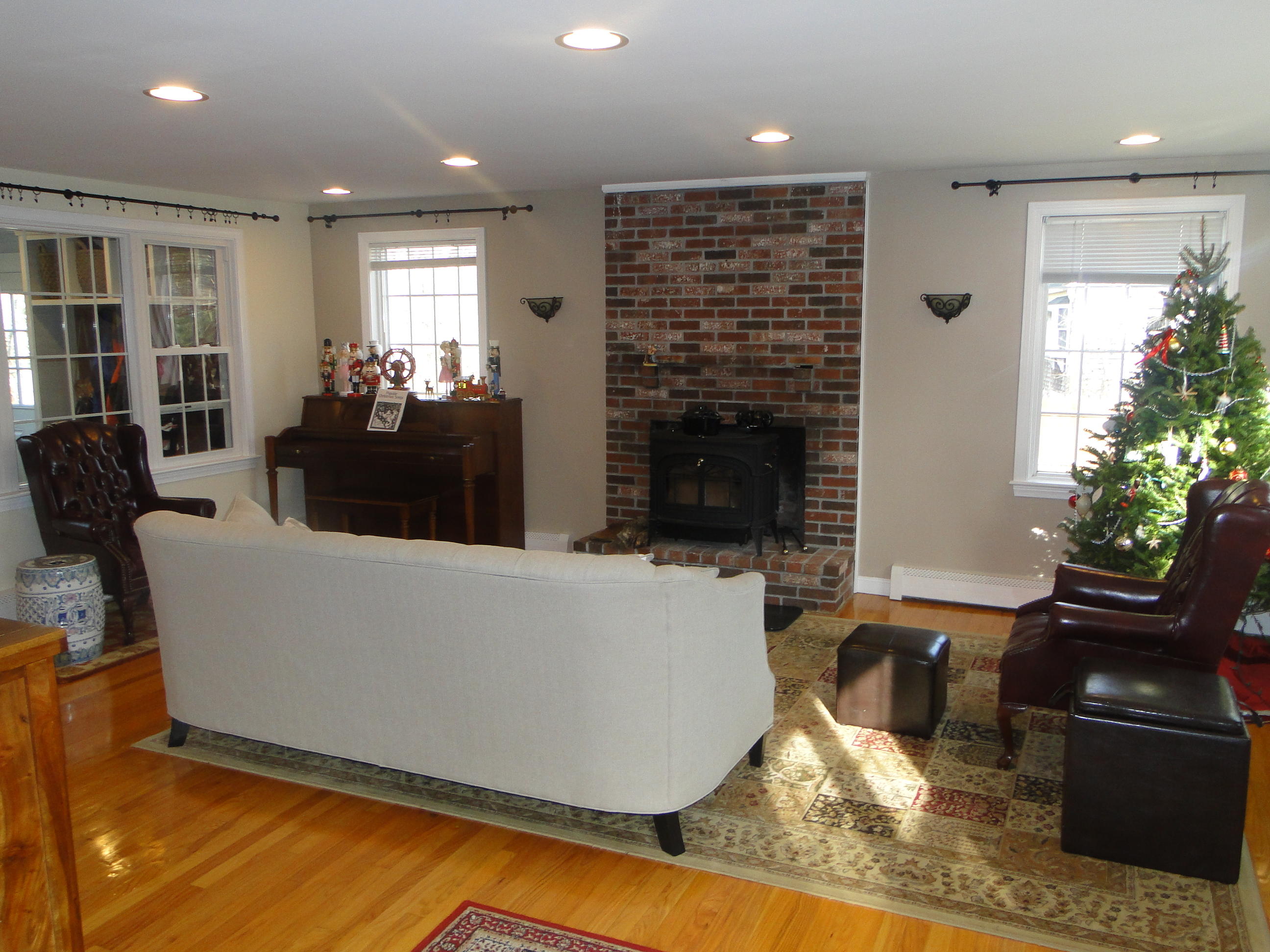 10 Bayview Road East Sandwich, MA 02537 - Photo 10 of 19 a living room with furniture a potted plant and a fireplace