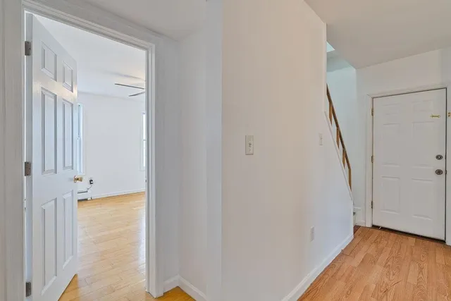 a view of a hallway with wooden floor