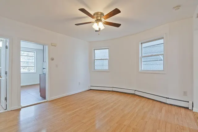 wooden floor in an empty room with a window