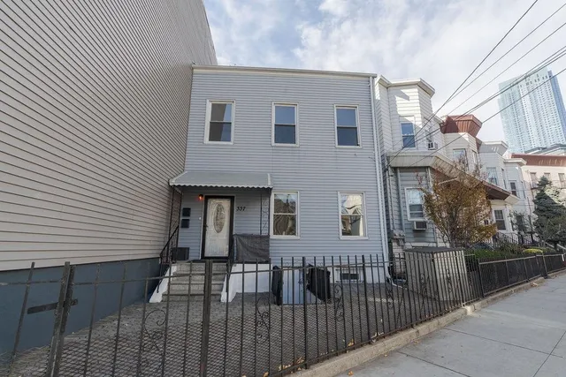 a view of a brick house with many windows