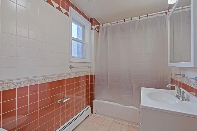 a bathroom with a shower curtain and a sink