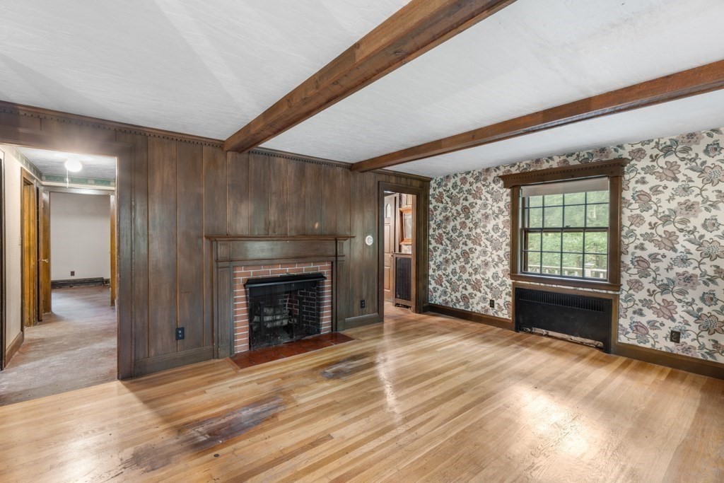 19 Forest Road Wakefield, MA 01880 - Photo 7 of 30 a view of an empty room with wooden floor fireplace and a window