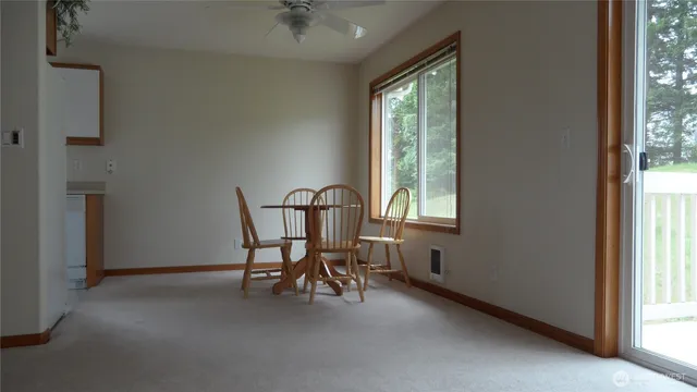 a view of a livingroom with furniture and a window