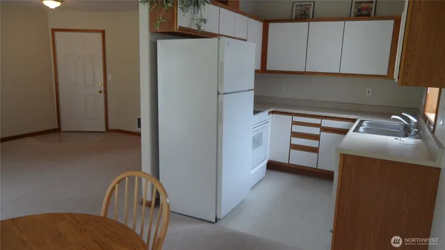 a kitchen with a refrigerator and cabinets
