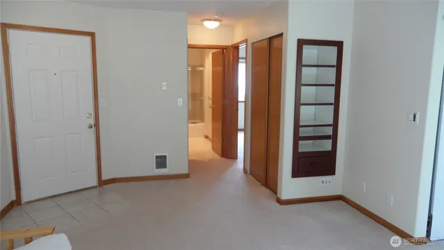 an empty room with windows and closet