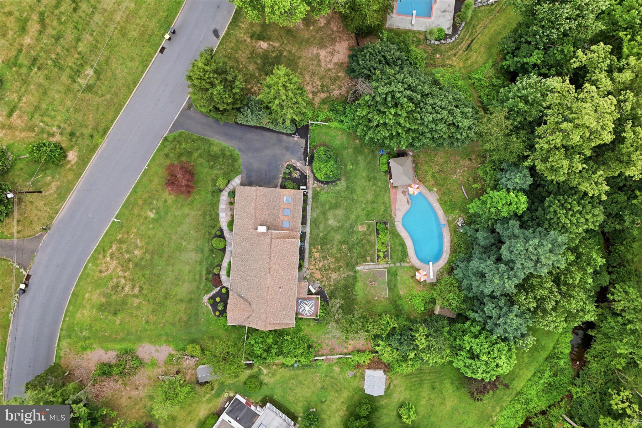 121 Gwynedd Manor Road North Wales, PA 19454 - Photo 48 of 59 Serene home with lush greenery and pool.