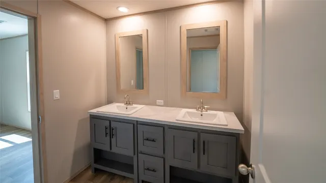 a bathroom with a double vanity sink and a mirror