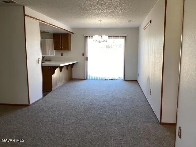 a view of a kitchen with a sink and a refrigerator
