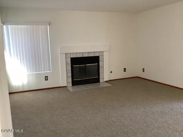 a view of an empty room with a fireplace