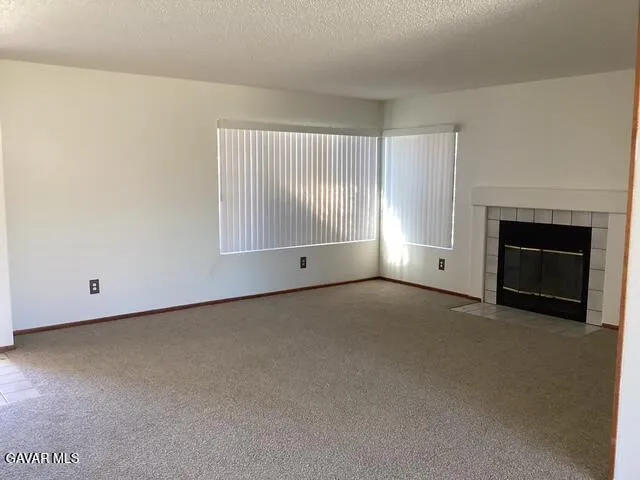 a view of empty room with a fireplace