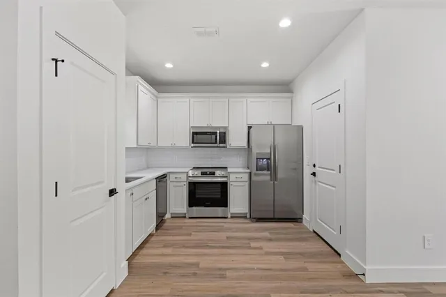 a kitchen with stainless steel appliances a refrigerator stove and sink