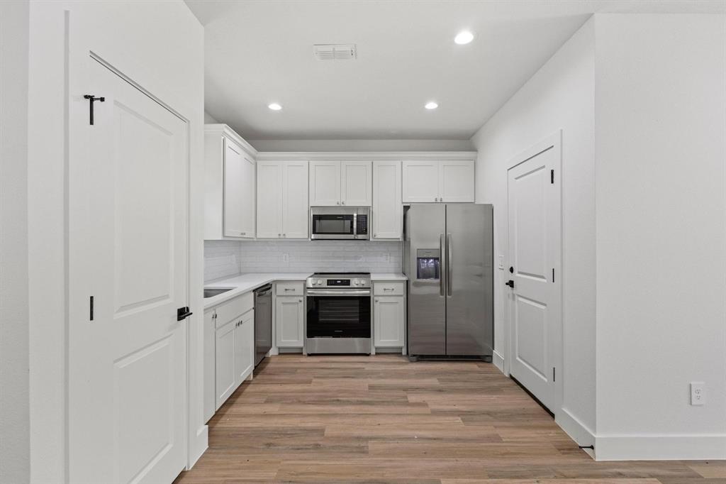 516 Florence Denison, TX 75020 - Photo 12 of 27 a kitchen with stainless steel appliances a refrigerator stove and sink