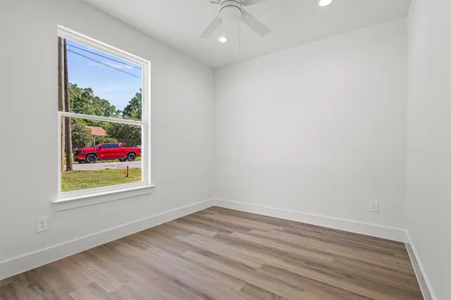 wooden floor in a room next to a window