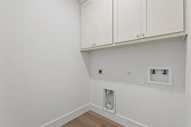 a view of storage and utility room with wooden floor