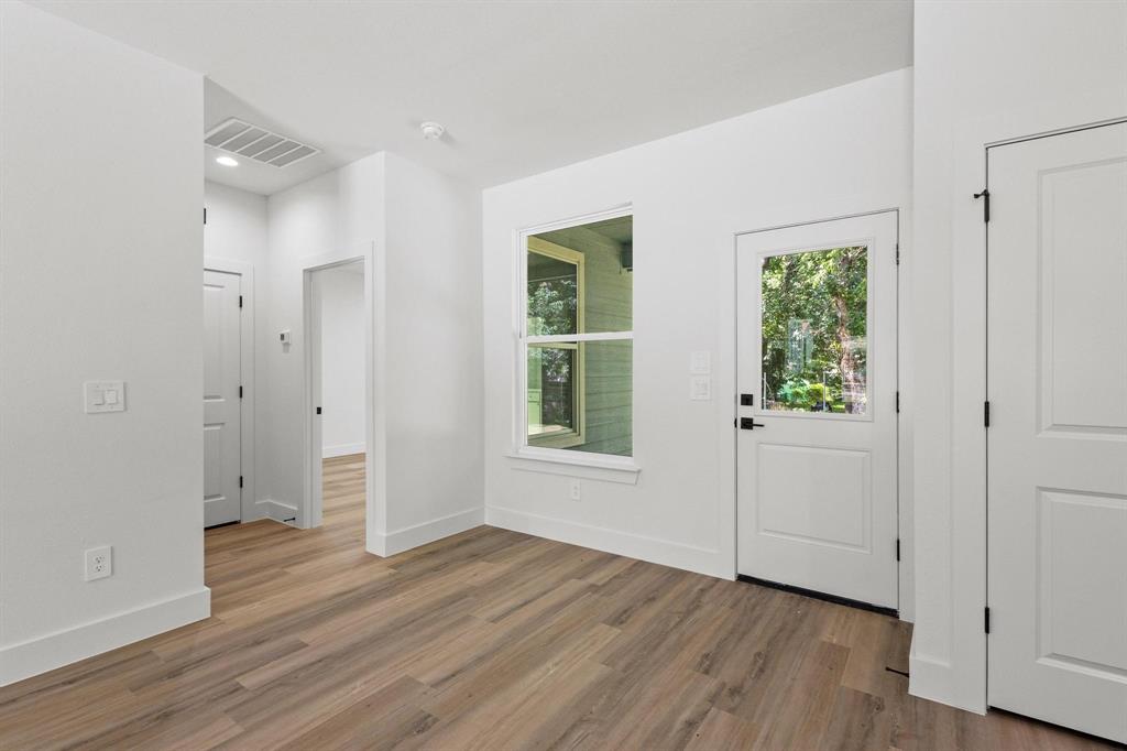 516 Florence Denison, TX 75020 - Photo 9 of 27 an empty room with wooden floor and windows