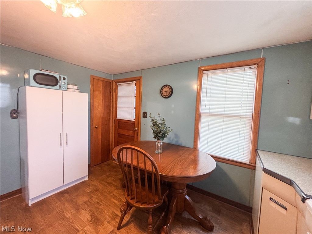 724 East Main Street Barnesville, OH 43713 - Photo 11 of 28 Dining area with dark wood finished floors and baseboards