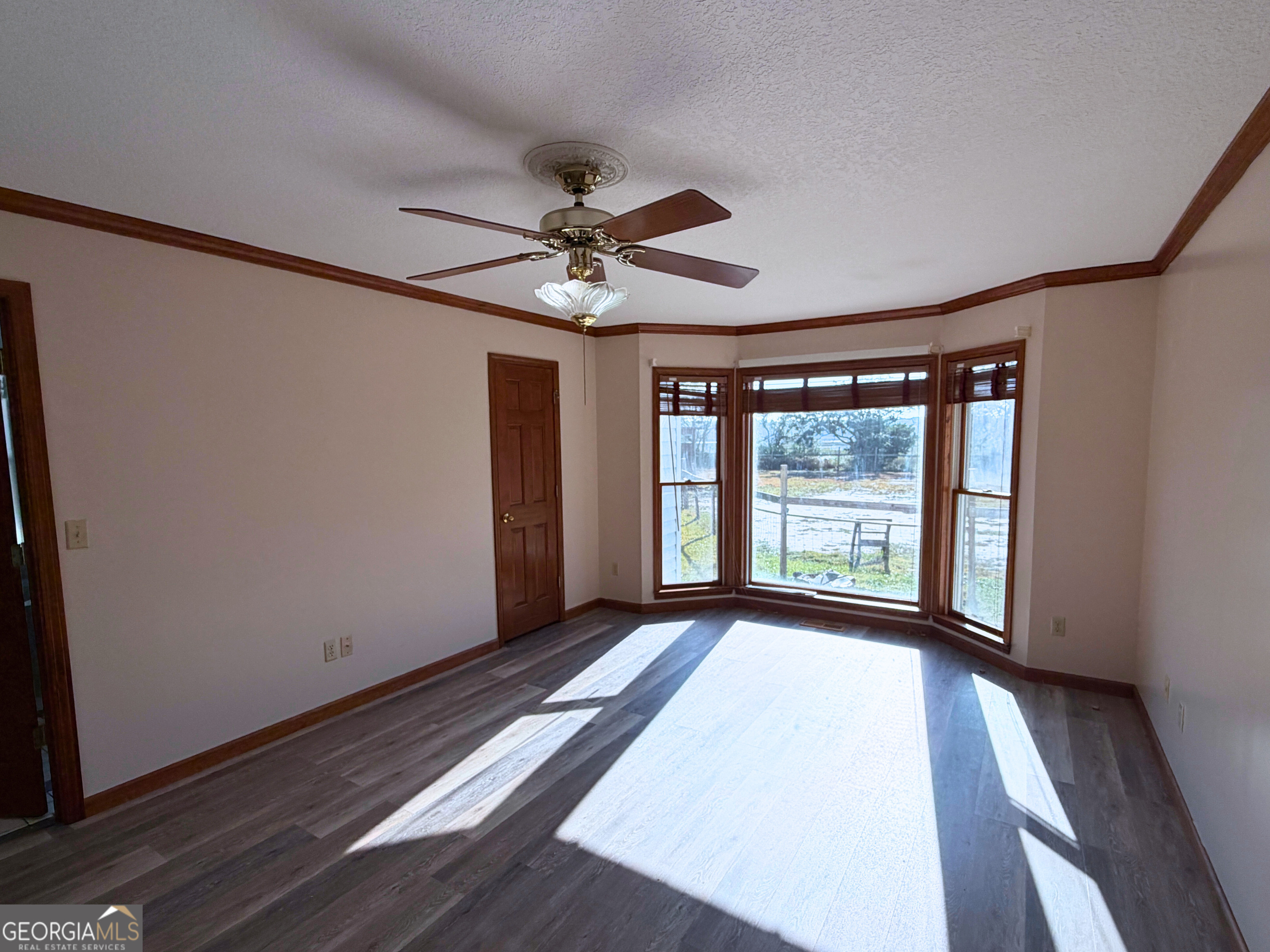 1818 Union Carbide Road Woodbine, GA 31569 - Photo 15 of 33 a view of an empty room with a window and wooden floor