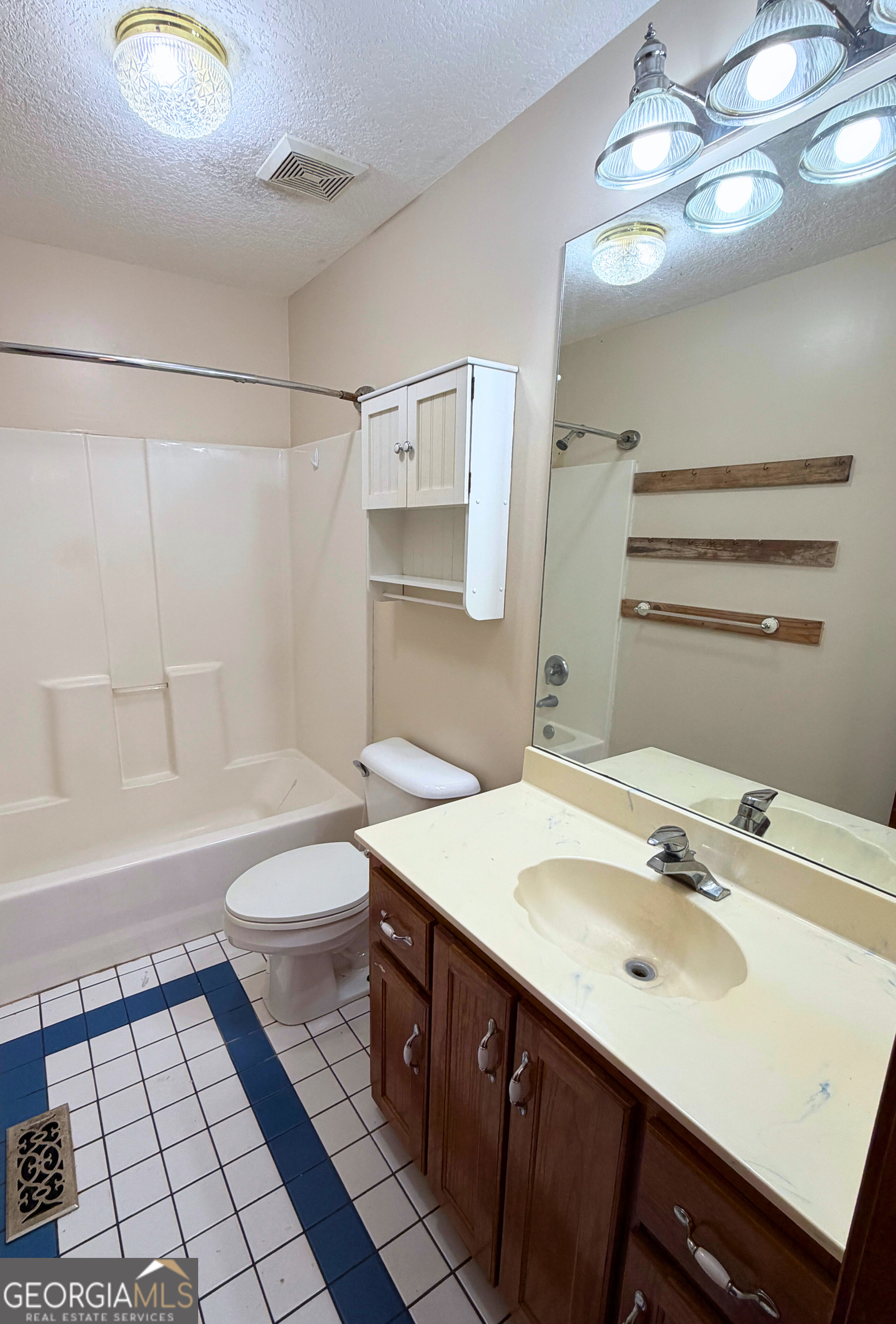 1818 Union Carbide Road Woodbine, GA 31569 - Photo 21 of 33 a bathroom with a sink a toilet a mirror and shower