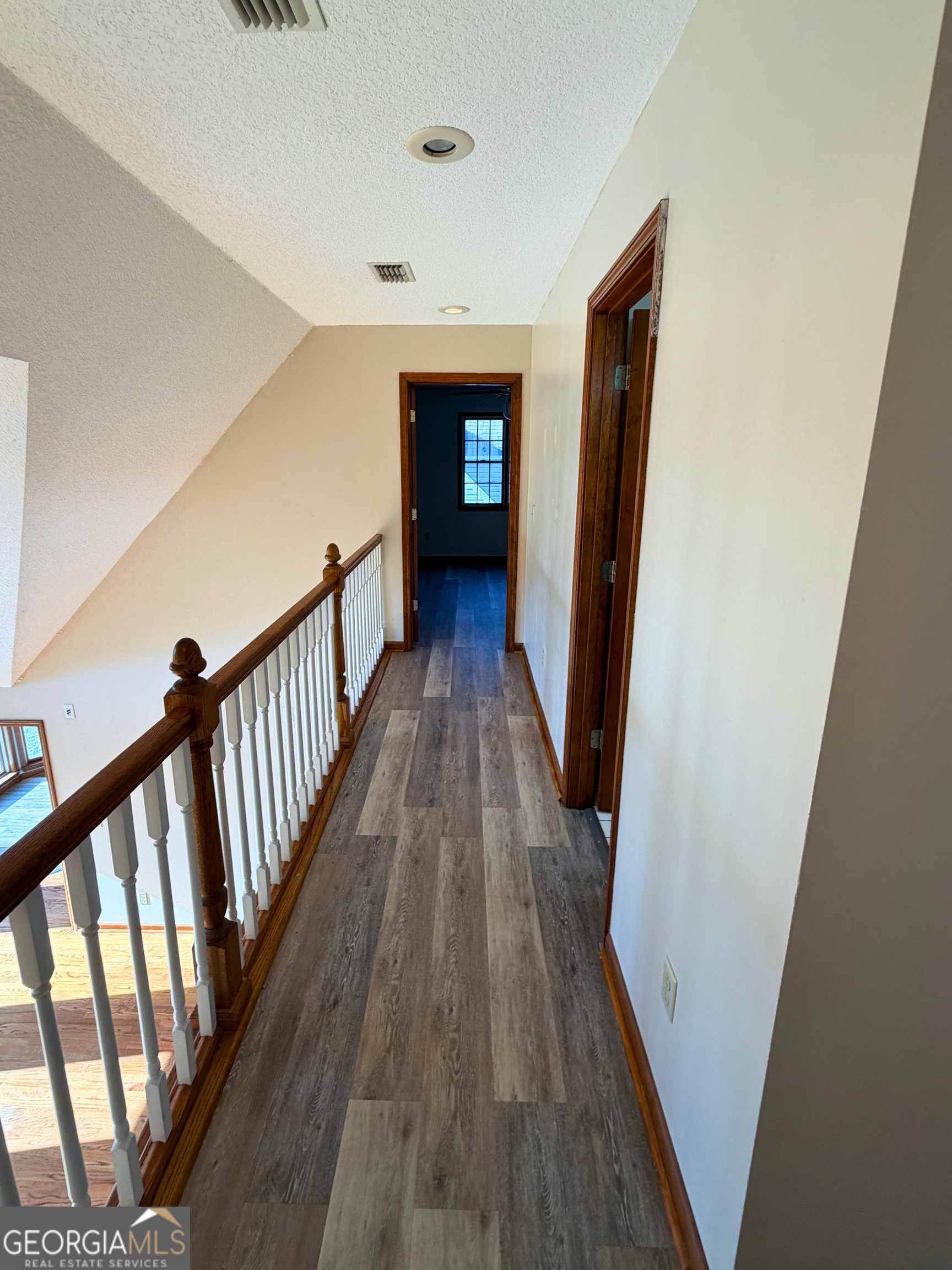 1818 Union Carbide Road Woodbine, GA 31569 - Photo 22 of 33 a view of a hallway with wooden floor and staircase