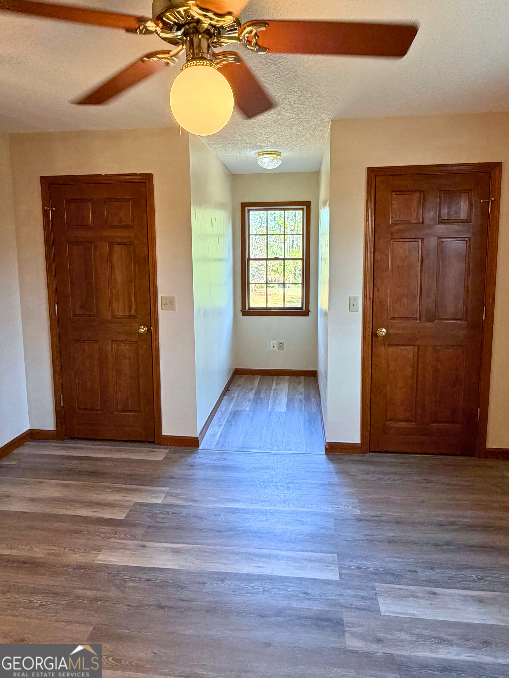 1818 Union Carbide Road Woodbine, GA 31569 - Photo 25 of 33 a view of an empty room with wooden floor and a window