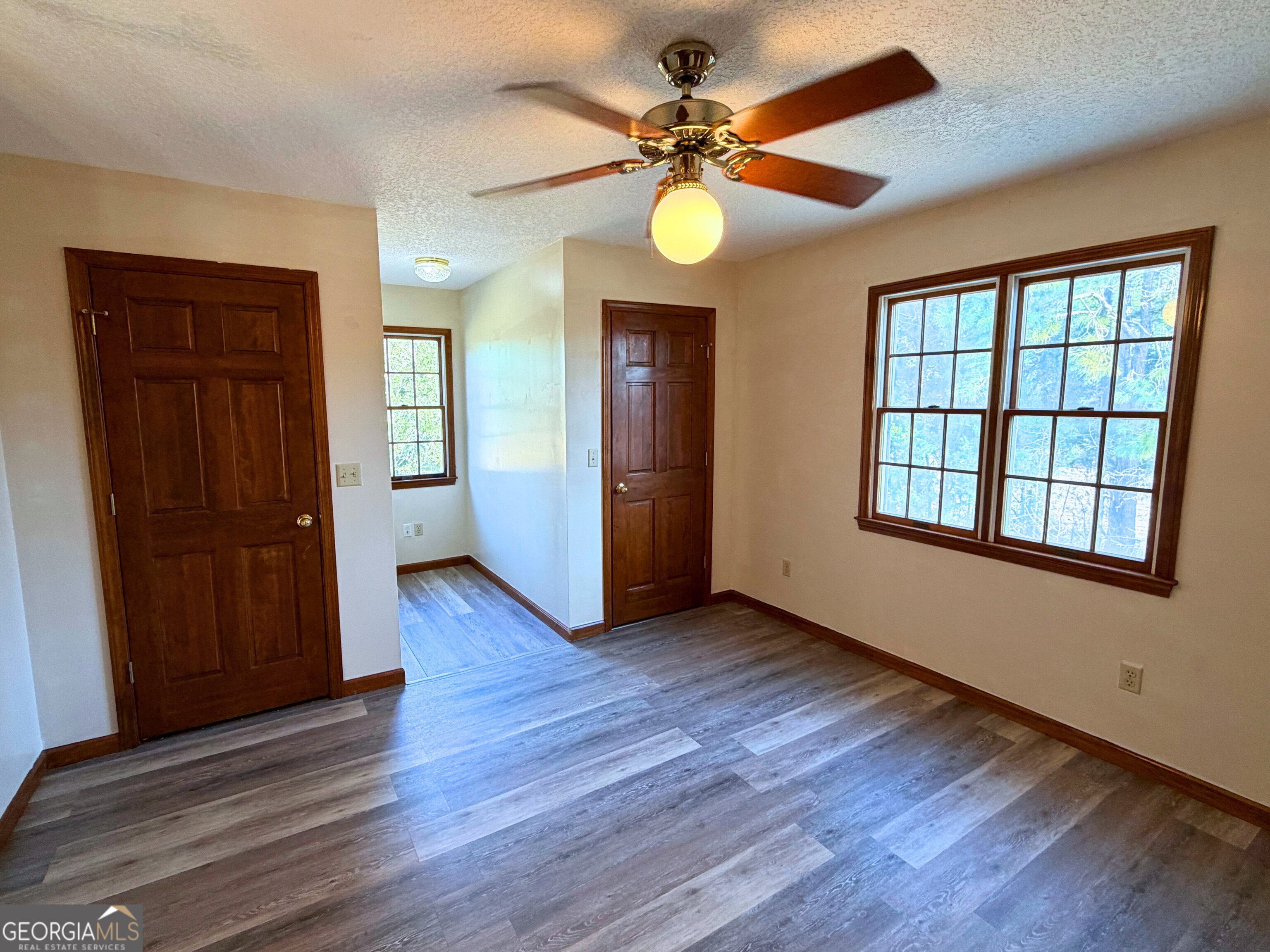 1818 Union Carbide Road Woodbine, GA 31569 - Photo 27 of 33 a view of an empty room with a window and wooden floor