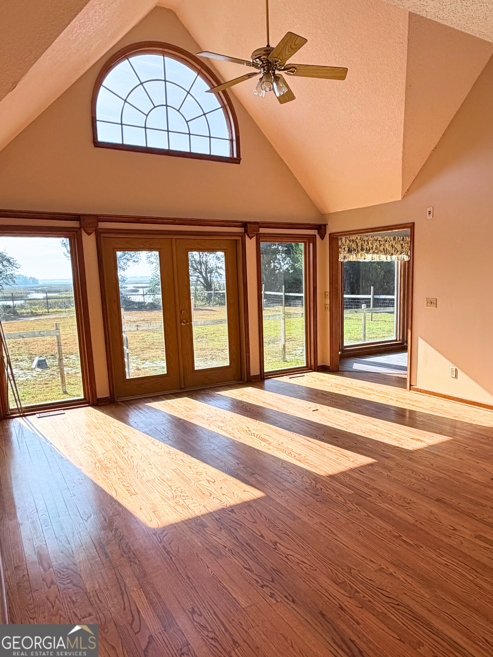 1818 Union Carbide Road Woodbine, GA 31569 - Photo 8 of 33 a view of an empty room with wooden floor and a window