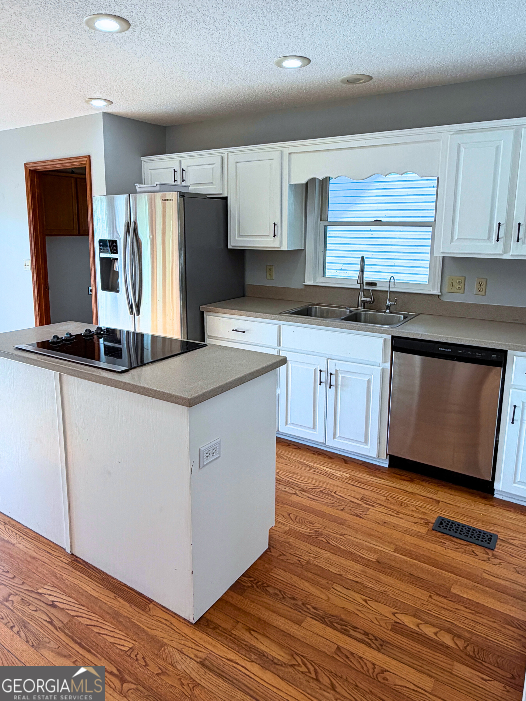 1818 Union Carbide Road Woodbine, GA 31569 - Photo 9 of 33 a kitchen with kitchen island granite countertop a sink stove and refrigerator