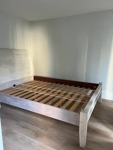 a wooden bench sitting in a kitchen
