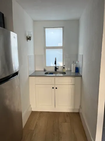 a bathroom with a sink a mirror and a window