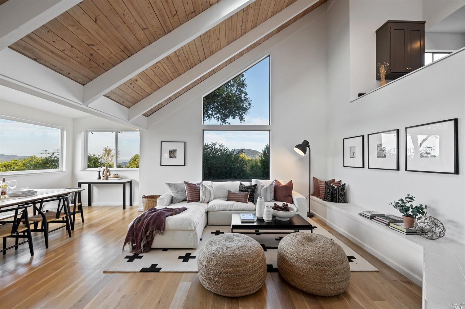 a living room with furniture and a floor to ceiling window