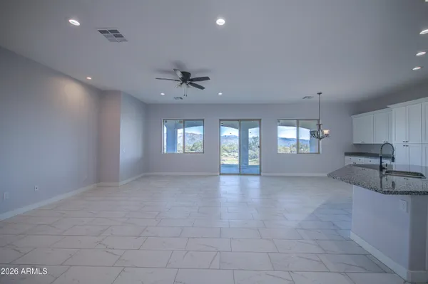 a view of kitchen with refrigerator and window