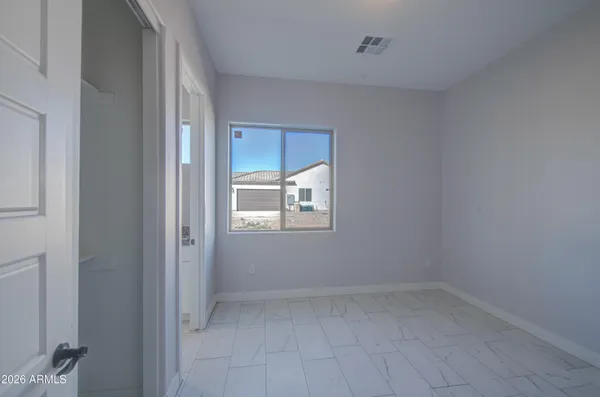 a bathroom with a granite countertop toilet sink and mirror