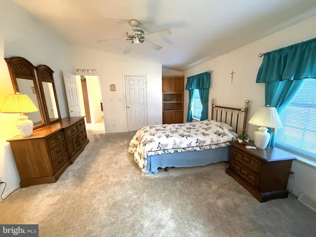 a bedroom with a bed couch and window