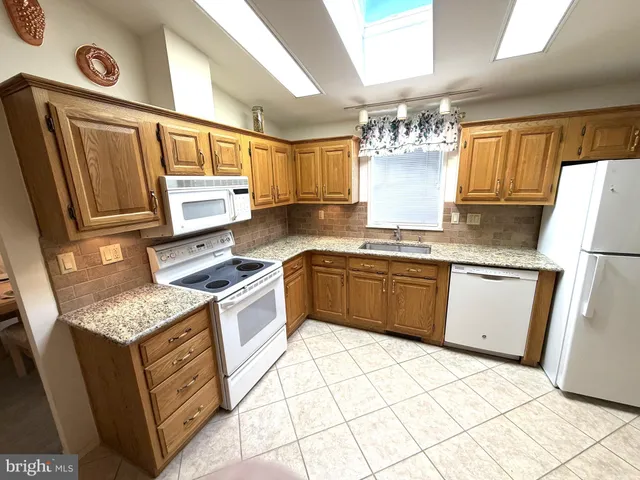 a kitchen with a stove a sink and a refrigerator