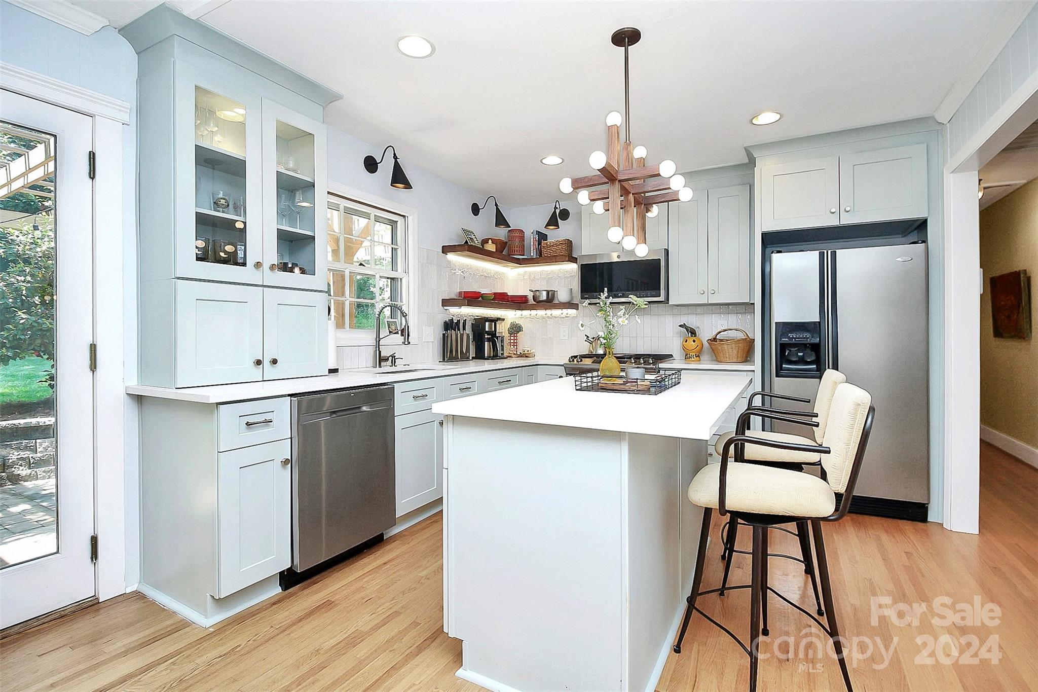 1011 Nancy Drive Charlotte, NC 28211 - Photo 20 of 44 a kitchen that has a lot of white cabinets a sink dishwasher and a stove with wooden floor