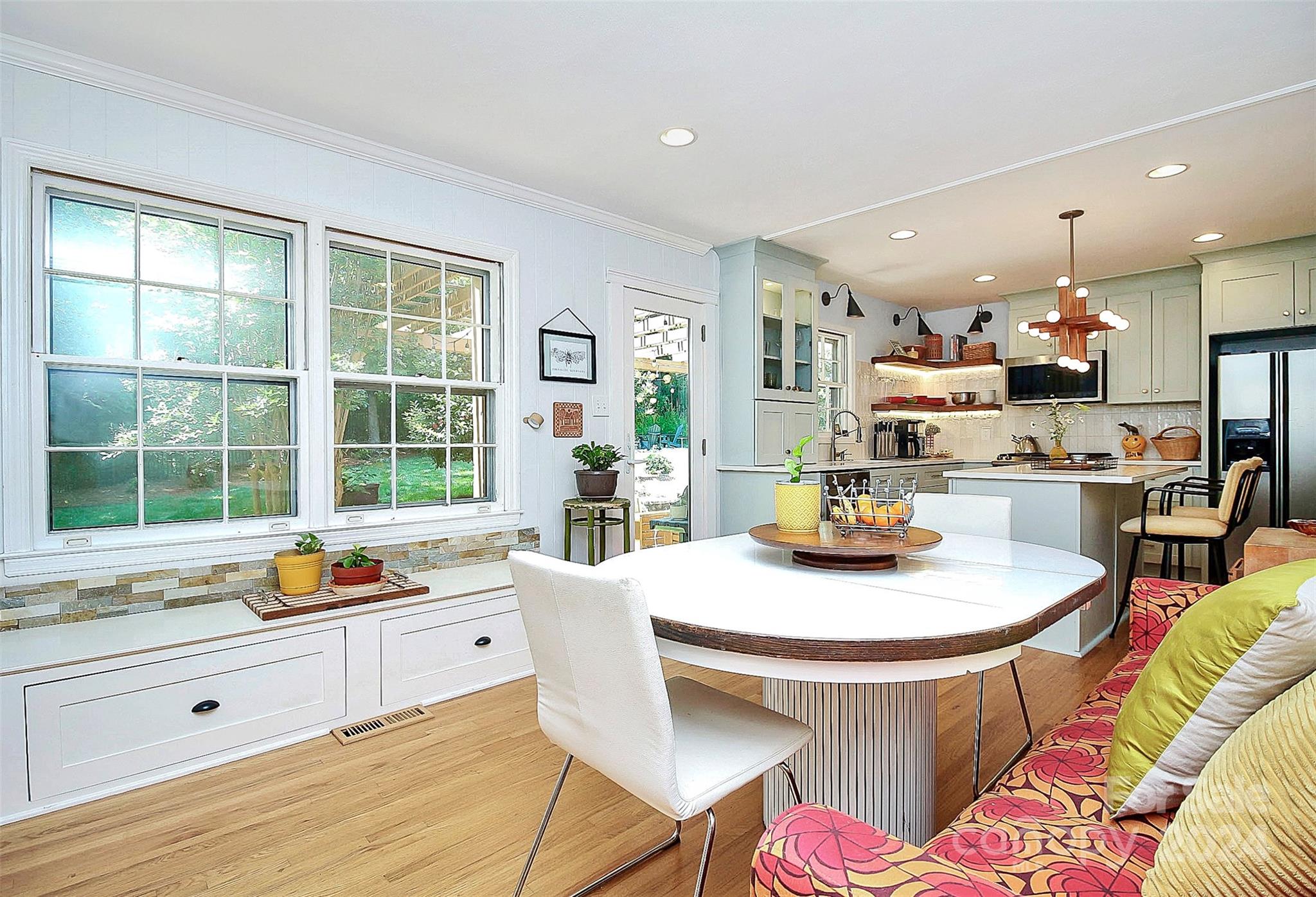 1011 Nancy Drive Charlotte, NC 28211 - Photo 25 of 44 a kitchen with a sink a stove a dining table and chairs