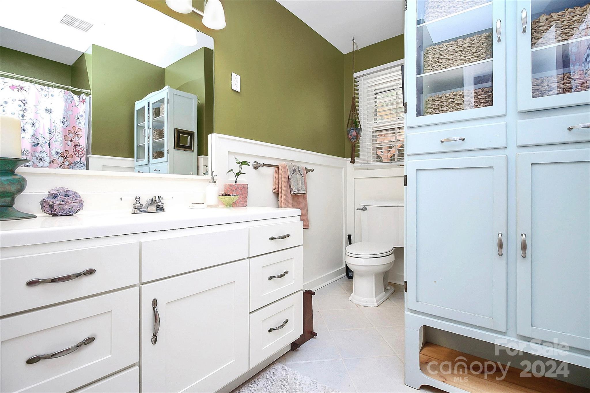 1011 Nancy Drive Charlotte, NC 28211 - Photo 30 of 44 a bathroom with a granite countertop toilet sink and a mirror