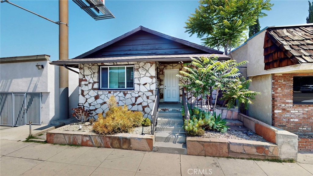 6851 Foothill Boulevard Tujunga, CA 91042 - Photo 7 of 50 a front view of a house with garden